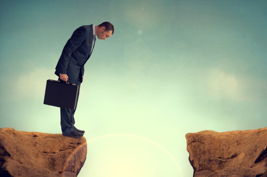 Man standing in front of precipice with briefcase